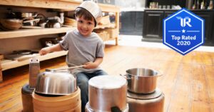 a little boy playing drum with cookware equipments